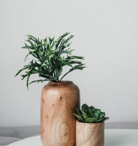 Tall and short wood-grain planters with greenery and a small succulent