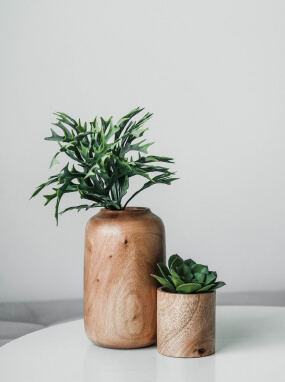 Tall and short wood-grain planters with greenery and a small succulent