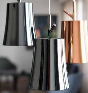 Flared pendant lights with a mirror-like silver finish and one copper-tone shade
