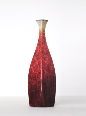Tall slender vase with a faceted body and deep red marbled finish fading to a pale neck